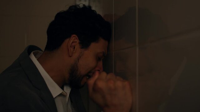 Man in prison cell losing sanity, showing despair and frustration