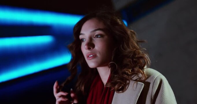 Thoughtful Young Woman in Blue Neon Light, Night City Portrait, Copy Space