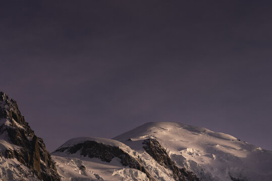 Mont Blanc illuminated against a purple twilight sk