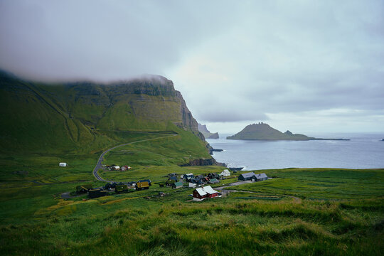 Small Faroese Village Beneath Towering Mountains