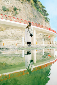 Girl's Reflection in Enoshima's Ocean Pools By the Bridge