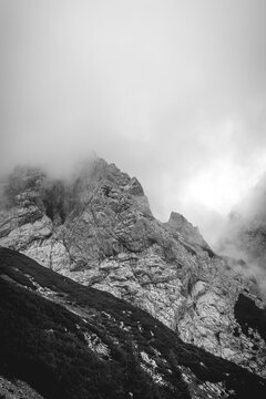 Jagged mountain peaks appearing through thick clouds