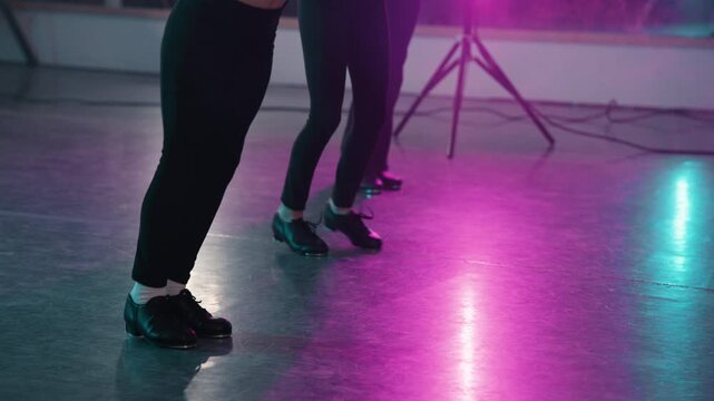 Young talented girls tap dancing routine in a modern dance studio