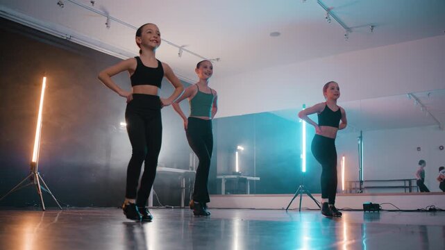Young talented girls tap dancing routine in a modern dance studio