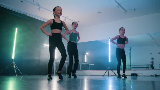 Young talented girls tap dancing routine in a modern dance studio
