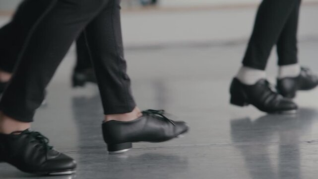 Young talented girls tap dancing routine in a modern dance studio