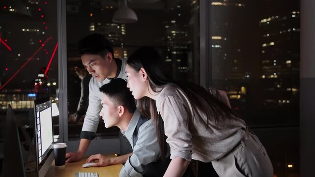 Team of diverse business focused on their work on computer, celebrating collective achievement successful completion of project with enthusiastic cheers, sharing enthusiastic high fives, genuine joy