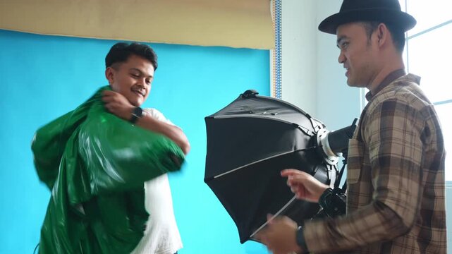 Male model wearing cloth props provided by photographer in his studio