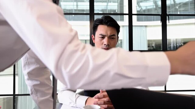 Stressful leader watches frustrated heated argument over documents, pointing fingers and escalating tension while discussing unsatisfactory work performance during negotiations meeting in boardroom