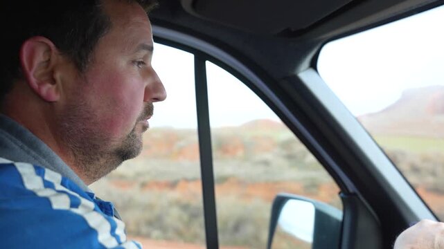 Farmer drives a van through the countryside heading to his fields to start an agricultural workday