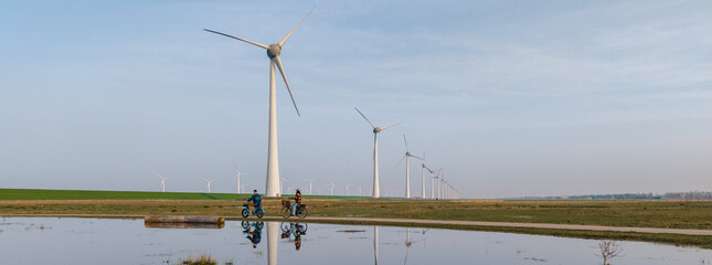 Scenic cycling near wind turbines in Urk, Flevoland, showcasing renewable energy landscape