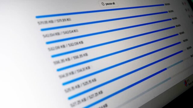 Uploading Progress Bars Displayed on a Computer Screen. The image features a close-up shot of a computer screen displaying multiple progress bars