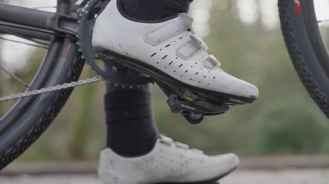Close up of cyclist shoe engaging clipless pedal on road bicycle