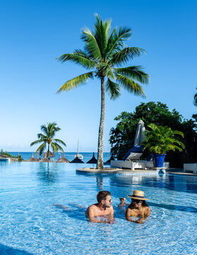 Enjoying a luxurious poolside experience in Mauritius under the clear blue sky