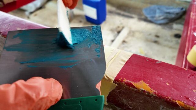 Filling fiberglass damage with polyester filler on boat gunwale