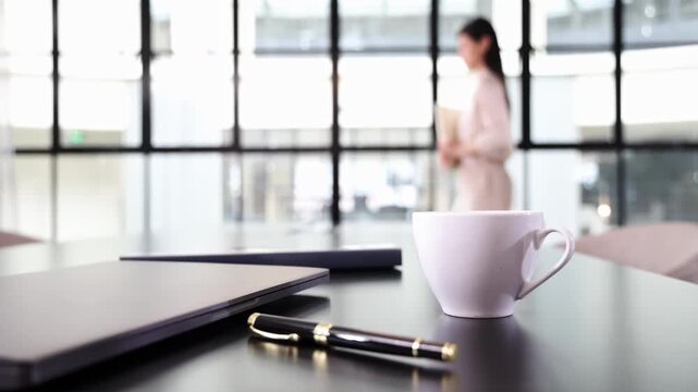 Unrecognizable female businesswomen executive doing paperwork reading document agreement learning contract standing by glass windows, modern glass-walled conference room, holding documents in hand