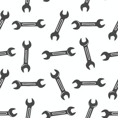 Obraz premium A seamless pattern of dark grey wrenches scattered on a white background