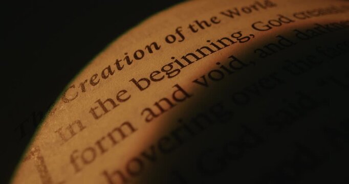 A detailed view of text on a page, highlighting the words Creation of the World and In the beginning. Smooth zoom effect