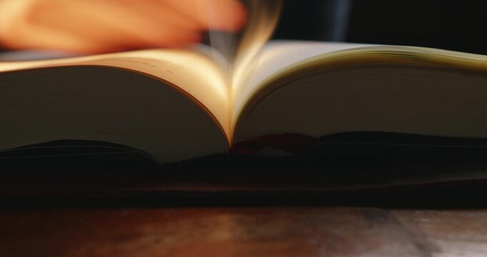 A closeup view of a book pages being turned, highlighting the texture and movement of the paper.