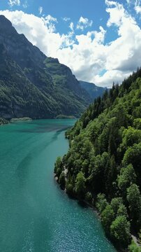 Kl&ouml;ntalersee turquoise mountain lake Kl&ouml;ntal Glarus Switzerland aerial drone vertical video