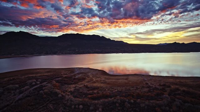 Aerial cinematic view of dawn breaking over Caballo Lake State Park in New Mexico.