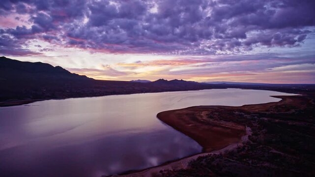 Aerial sunrise landscape with glowing clouds above Caballo Lake State Park in New Mexico desert.