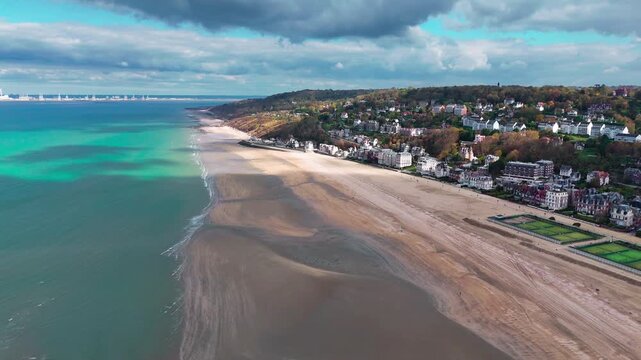 Aerial drone view seaside of the neighboring towns of Trouville-sur-Mer and Deauville, Normandy, France, October 20, 2025. High quality 4k footage