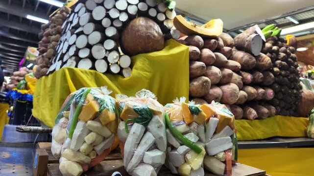 revealing shot of pre-cut vegetable packs for traditional soup, showcasing fresh auyama and yucca amidst a colorful and abundant street market stall