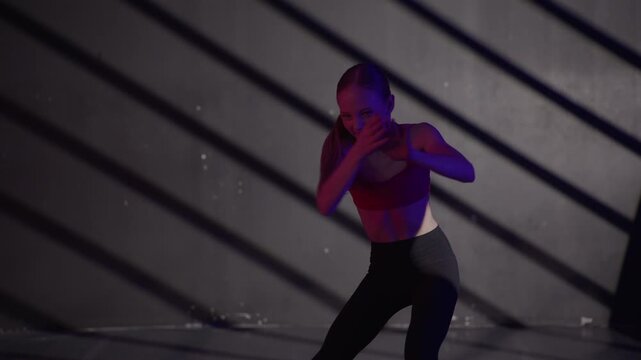 Young modern girls in dance class performing with wall shadows