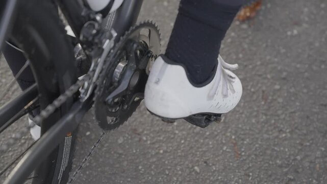 Close up of cyclist shoe pedaling bicycle drivetrain in Penha Guimar&atilde;es