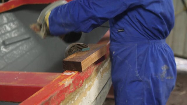 Sawing mahogany wood for fiberglass boat oarlock repair