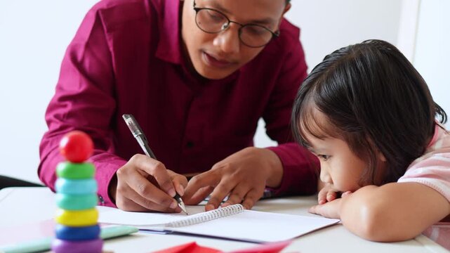 Patient Asian tutor explaining grammar to focused little girl during private lesson