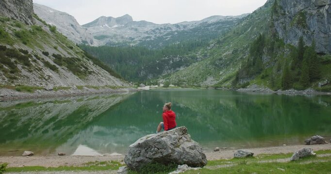 Hiker Resting Above Lake Krn In Julian Alps Slovenia