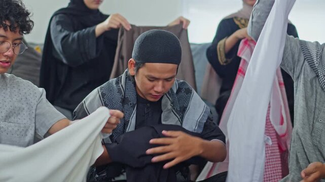 Young Muslim family joyfully folding clothes and packing together for Eid mudik homecoming journey