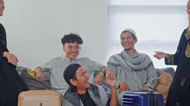 Happy Muslim family laughing together with suitcases preparing for Mudik homecoming