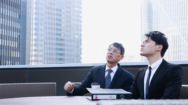 Business partners conversation with meeting outdoor for planning or discussion project on modern rooftop terrace, building city real estate with client, developer management for commercial investment