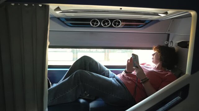 Sleeper Bus Mobile Gaming Relaxation. Travelers Find Peace Through Simple Phone Games While Journeys. Passengers Unwind And Relax By Playing Straightforward Mobile Games Throughout Their