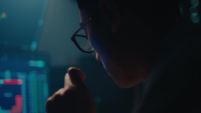 A cinematic close-up of a professional stock trader wearing glasses, reflecting the blue light of financial charts as he intently analyzes market data in a dark, moody office.