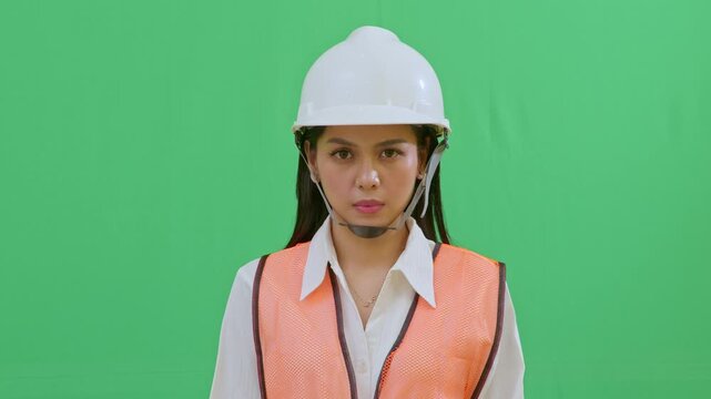 A tight shot of a female engineer with a serious and focused expression, observing site progress intently. Professional look reflecting competence and responsibility.
