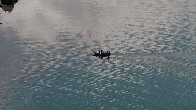 Aerial view of fishermen gliding across calm waters of Lake Atitlan Guatemala