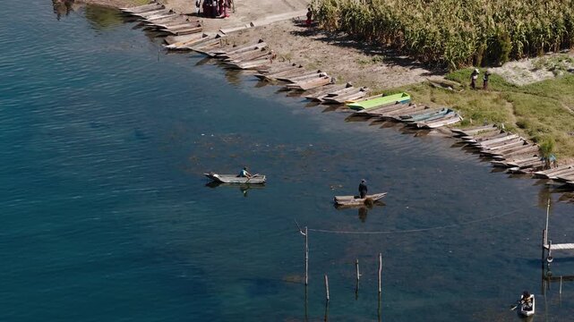Aerial view of local fishermen drifting wooden boats on Lake Atitlan