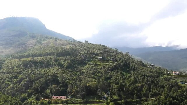 The hilly landscape of Vattavada in Idukki, Kerala, India, featuring terraced farmland and residential buildings