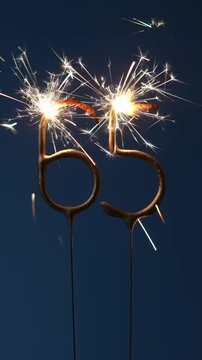 65 years anniversary background made with Bengal fires in the form of number Sixty five. Vertical footage.