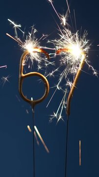 67 years celebration festive background made with Bengal fires in the form of number Sixty seven. Vertical footage.