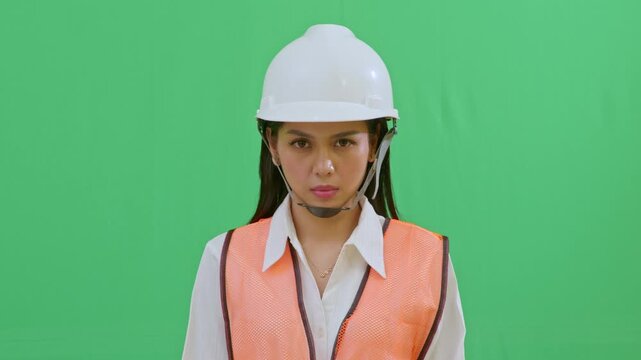 A tight shot of a female engineer with a serious and focused expression, observing site progress intently. Professional look reflecting competence and responsibility.
