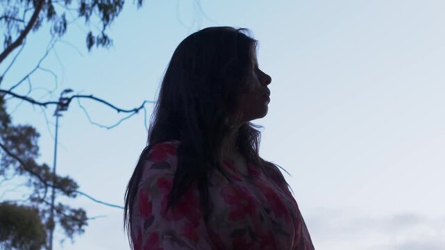 A woman&rsquo;s silhouette against a sunset sky in Croydon Park, Melbourne, highlighting serene beauty and peaceful dusk. Captured with soft lighting, natural composition, and tranquil ambiance.