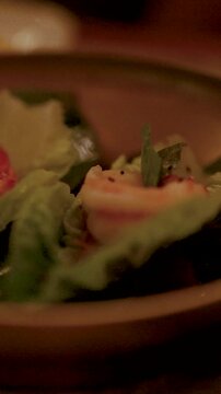 Vertical Close-Up of Gourmet Shrimp Miang Kham in Warm Light