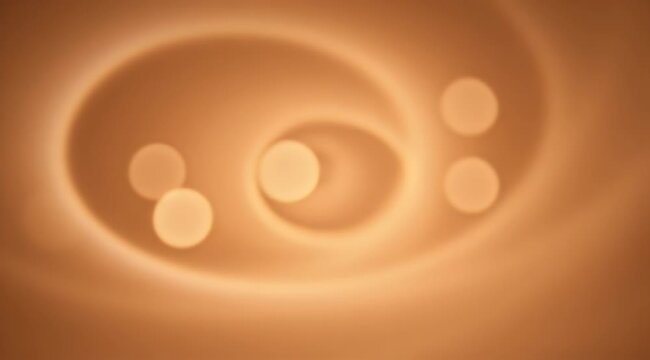Three soft, blurry light orbs float within warm brown, swirling, gradient abstract patterns