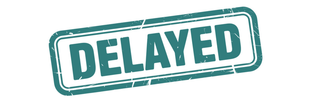 A teal rectangular stamp displaying the word delayed in bold white letters
