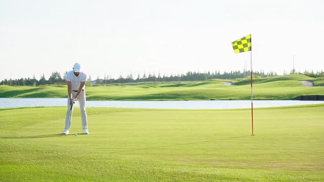 Golfer male golf sport athlete playing golf for fitness, workout or exercise enjoying vacation luxury resort using driver on a sunny summer day rising grass up